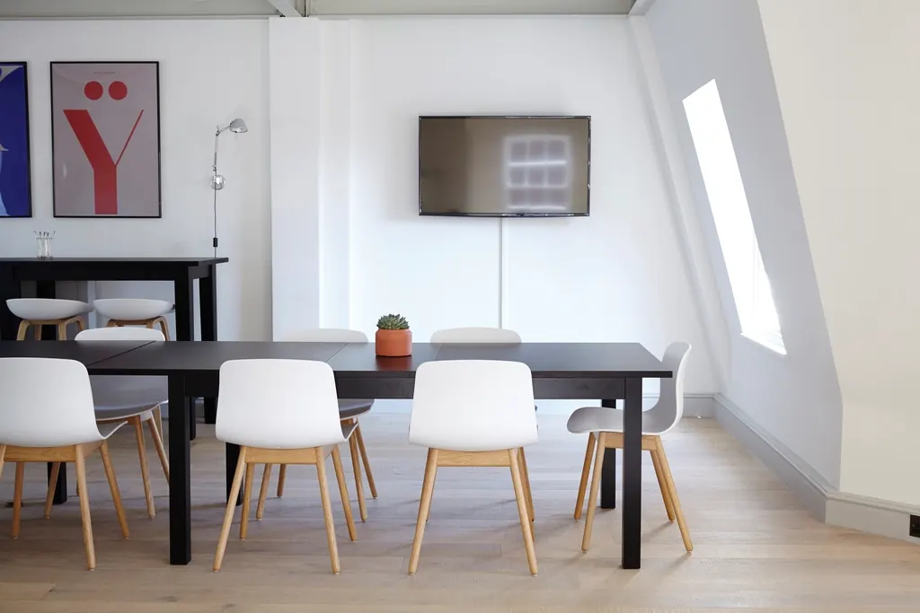 Bright office meeting room with a long table and chairs