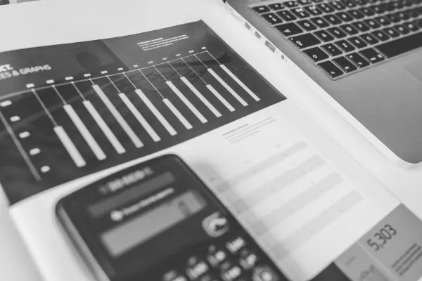 Calculator lying on a printed bar chart report