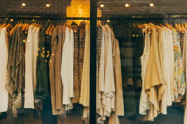 Clothing hanging on a rail in a fashion store