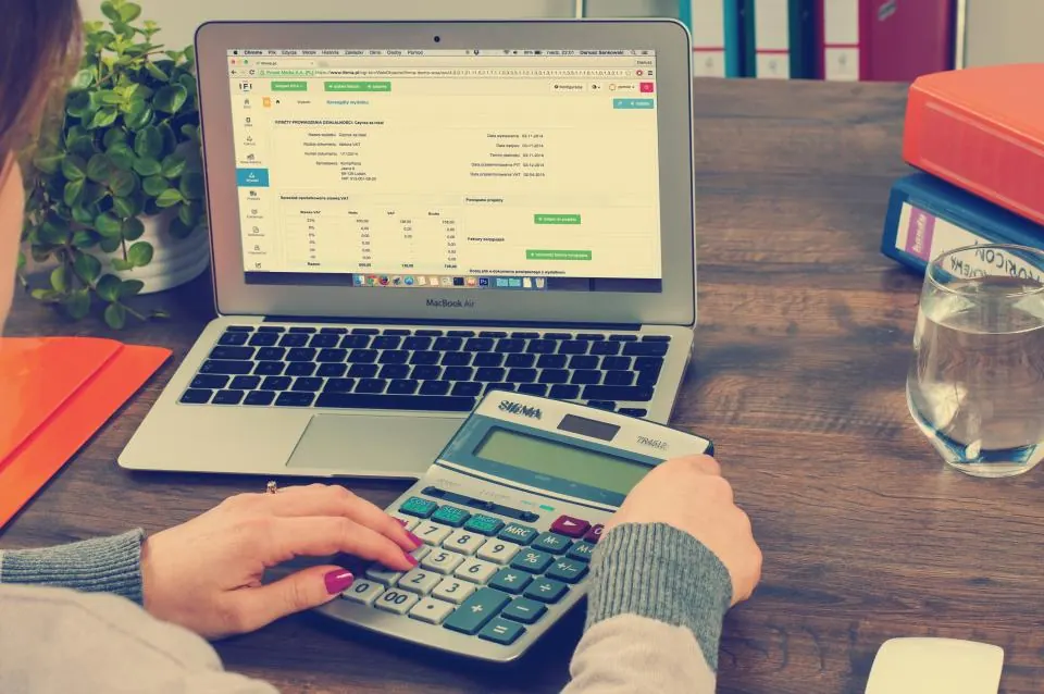 Controller checking month-end ledger figures on two monitors
