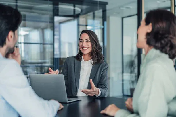 Account manager in conversation with a customer at an office desk