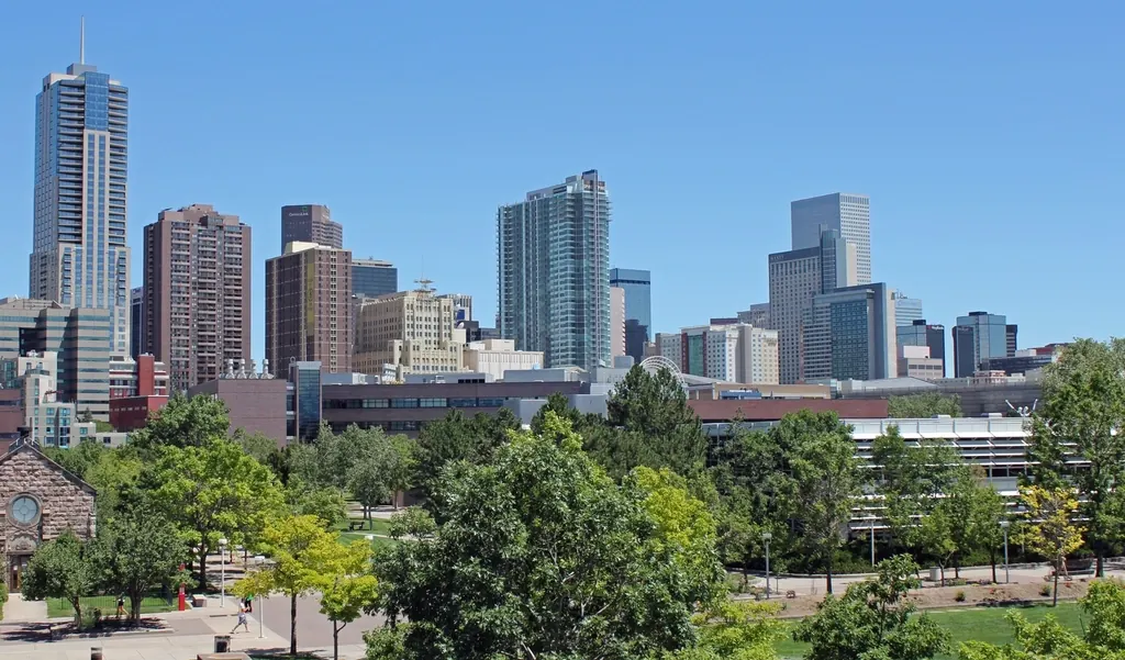 Denver downtown skyline with the Rocky Mountains behind it