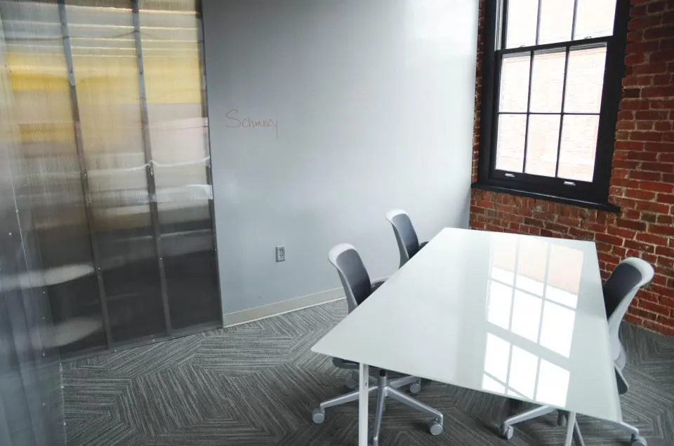 Empty meeting room with a white table and chairs