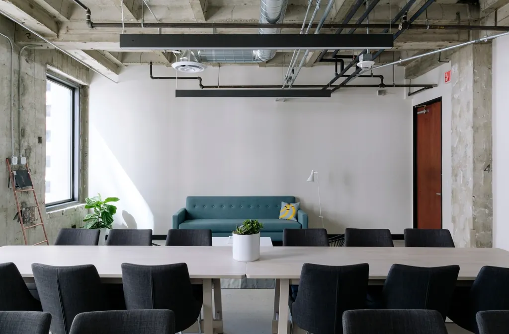 Empty open plan office with a meeting table