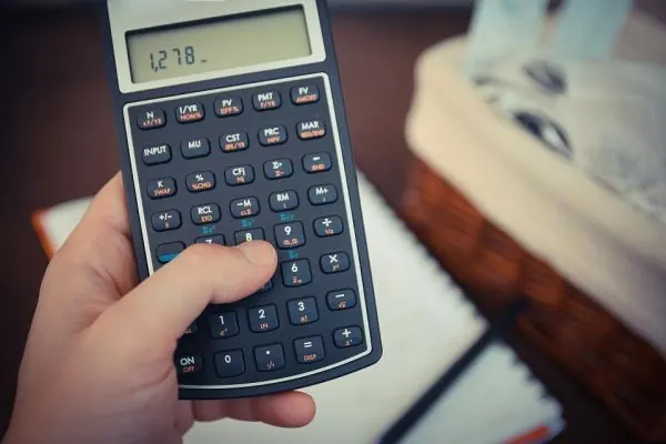 Hand holding a financial calculator