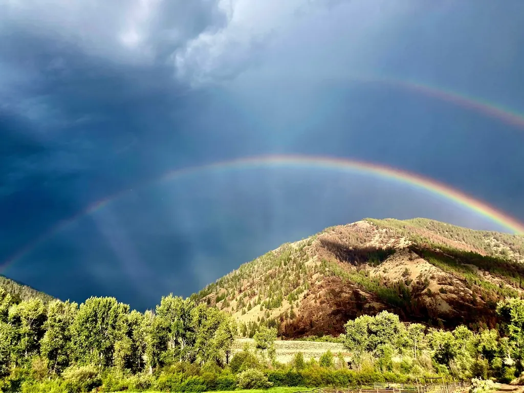 A rainbow over green hills in Idaho