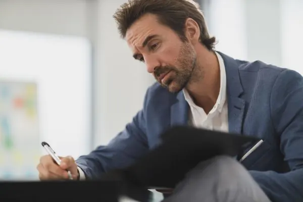 Man making notes in a notebook