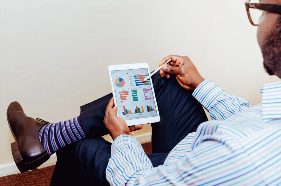 Manager reviewing a tablet while seated in an office chair
