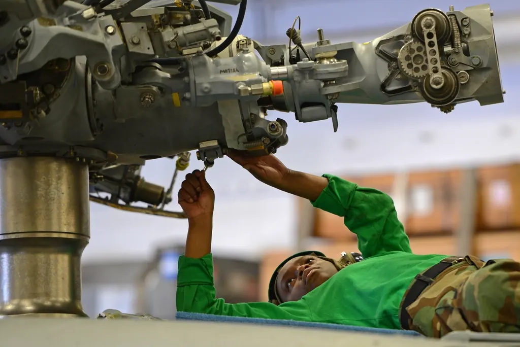 Mechanic working on the underside of heavy machinery