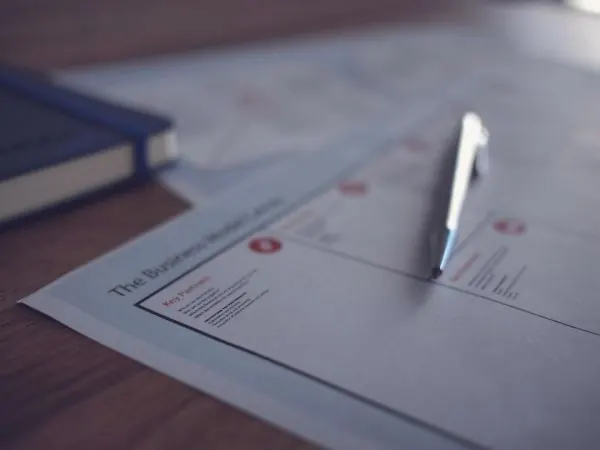 Pen resting on a printed business document