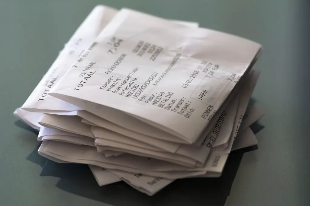 A loose pile of crumpled paper receipts