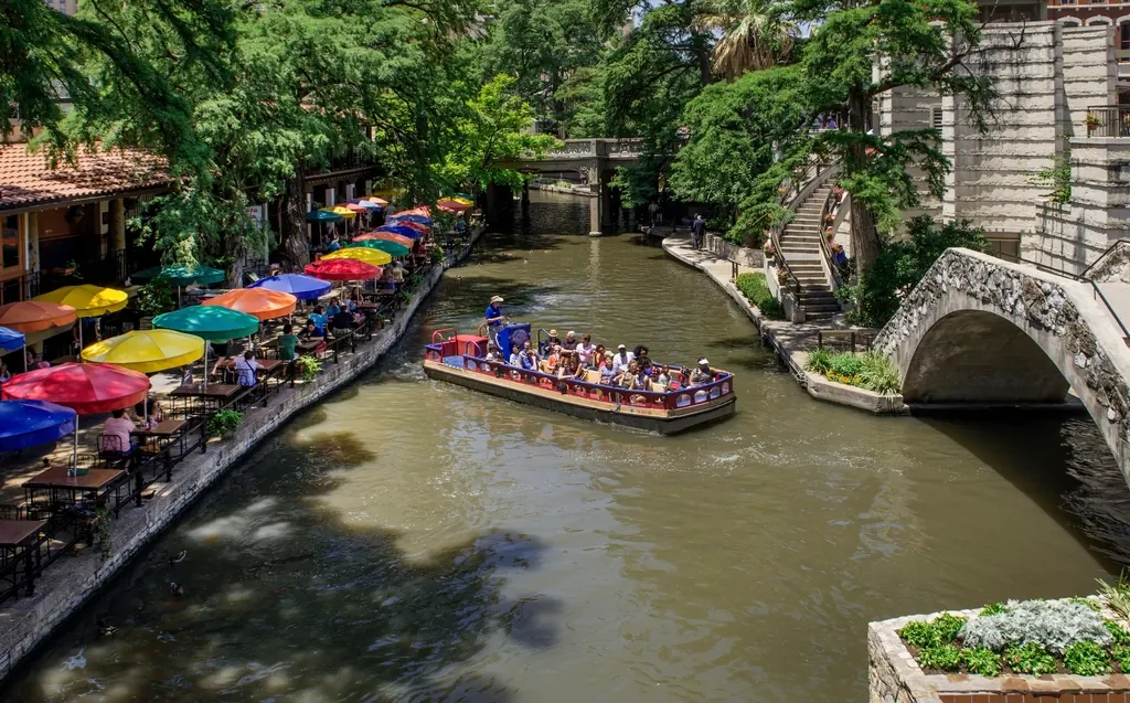San Antonio River Walk path lined with trees and cafes