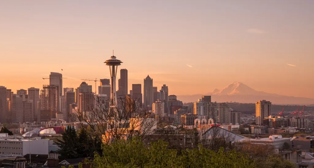 Seattle skyline and Space Needle at sunset with Mount Rainier beyond