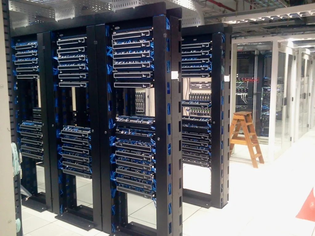 Rows of black server racks in a data room