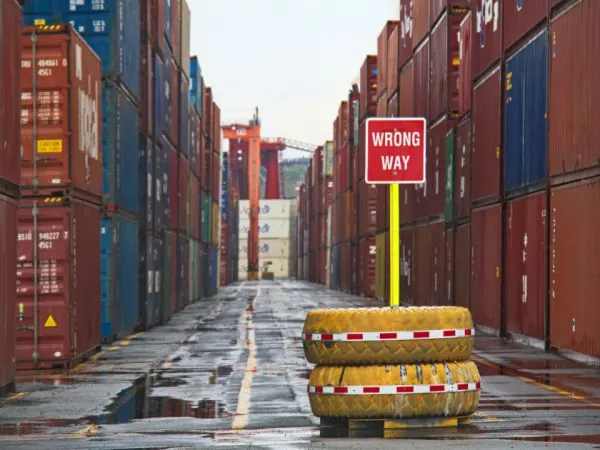 Shipping container yard with a wrong way sign