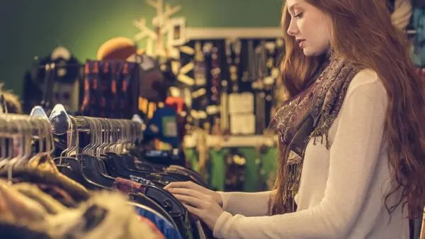 Shopper browsing a clothes rack in a boutique