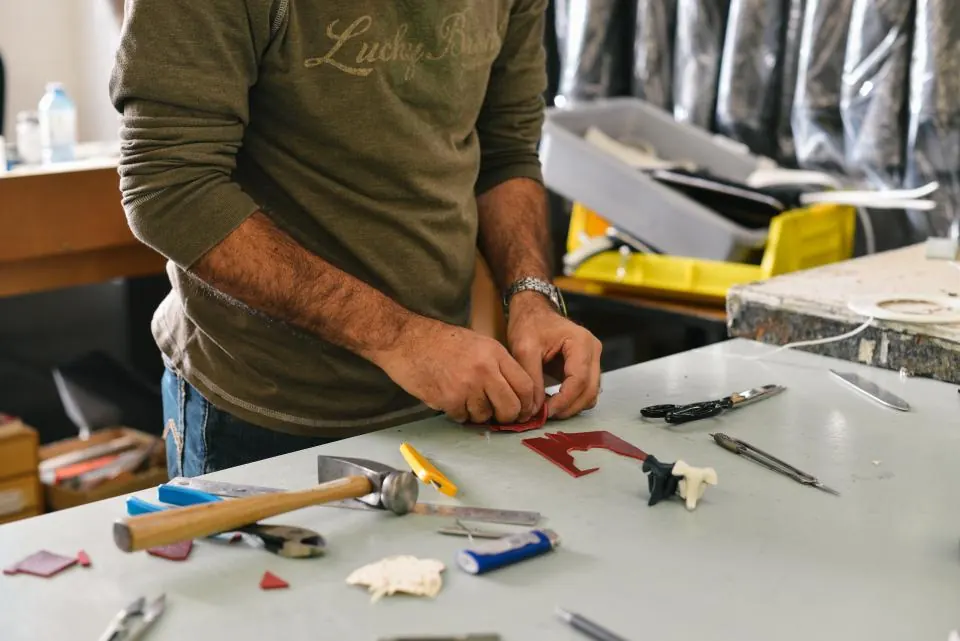 Technician assembling parts at a workshop bench
