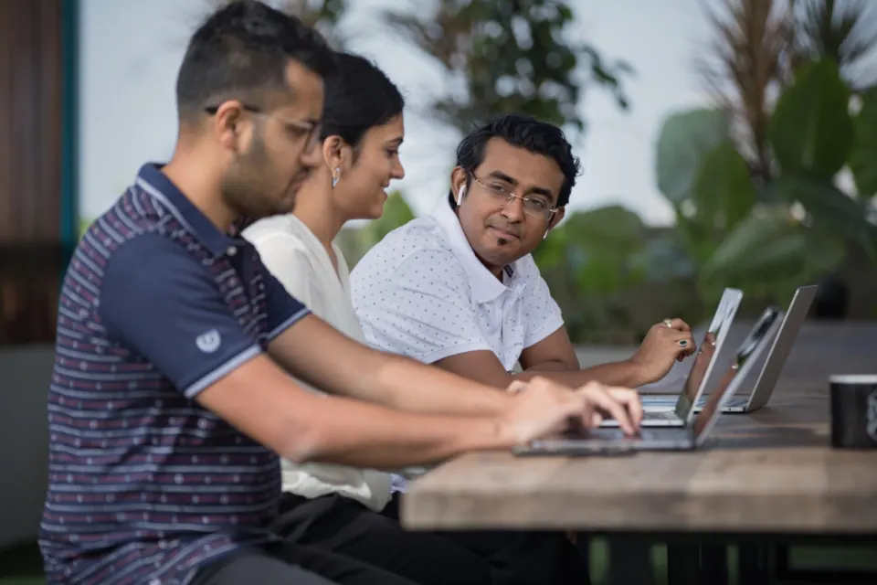 Two colleagues working together at a laptop