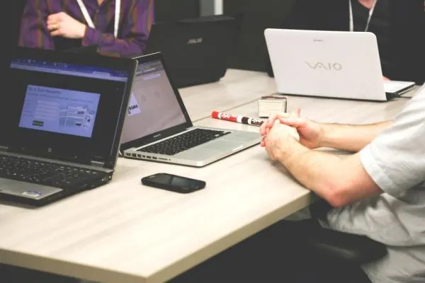 Two laptops side by side on a white desk