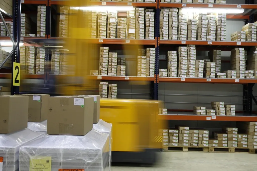 Warehouse shelving stacked with stock boxes