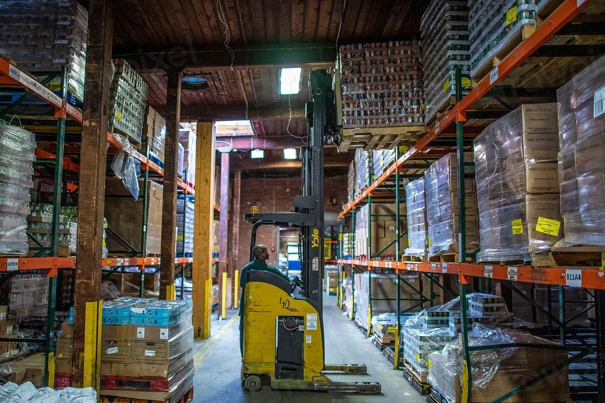 Warehouse worker scanning a barcode on a stocked shelf