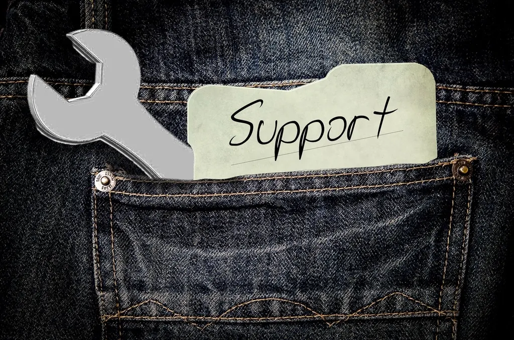 Wrench and a tag reading Support in a jeans pocket